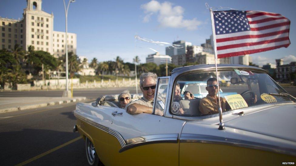 Retiree Lance Veit (C), 65, from California, enjoys a ride in a vintage car at the seafront Malecon during a cultural exchange trip in Havana, July 11, 201