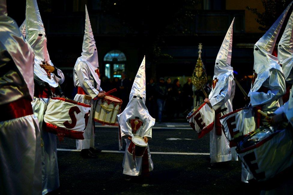 Penitents take part in the Procession del Nazareno