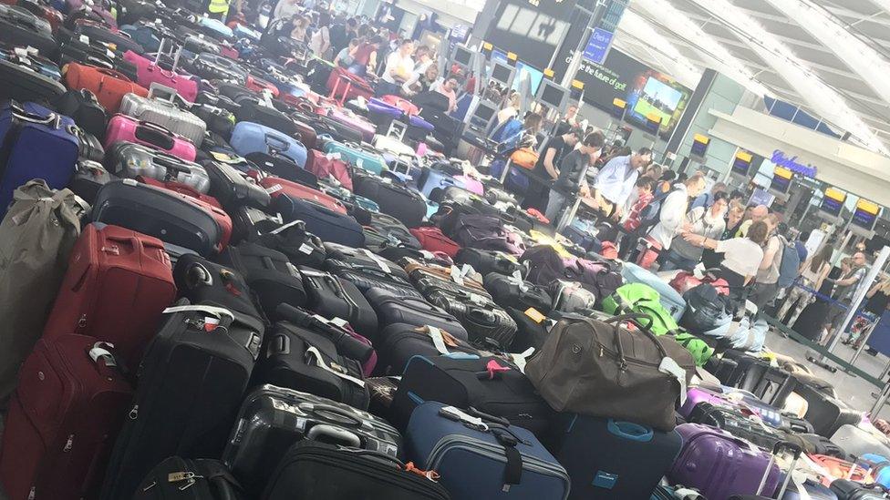 Piles of checked luggage on the floor in the Heathrow