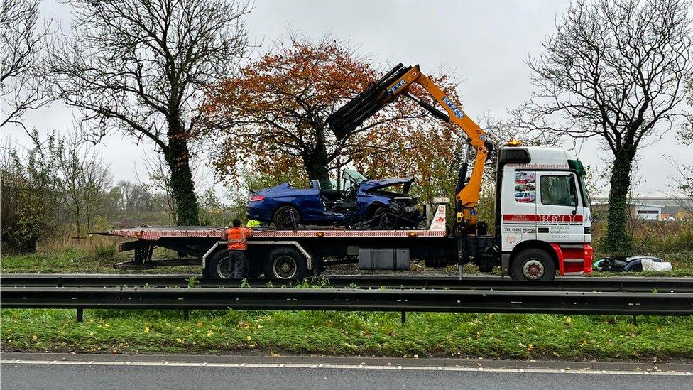 Crashed car and recovery truck
