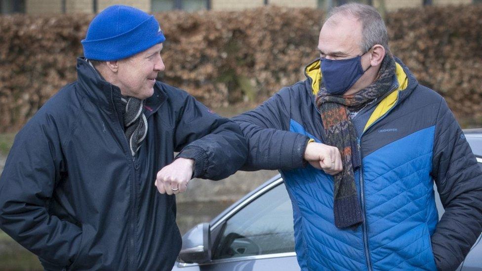 Willie Rennie and Ed Davey elbow bump each other