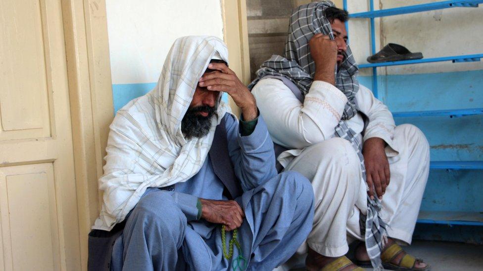 Relatives attend the funeral of an Afghan man who was killed in a suicide attack at Kabul bank, in Kandahar, Afghanistan