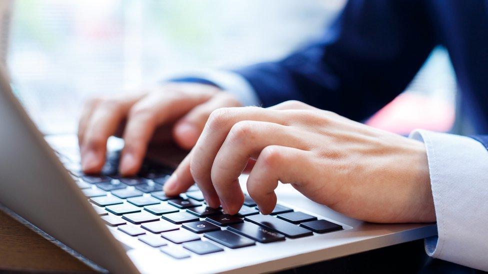 Man typing on computer