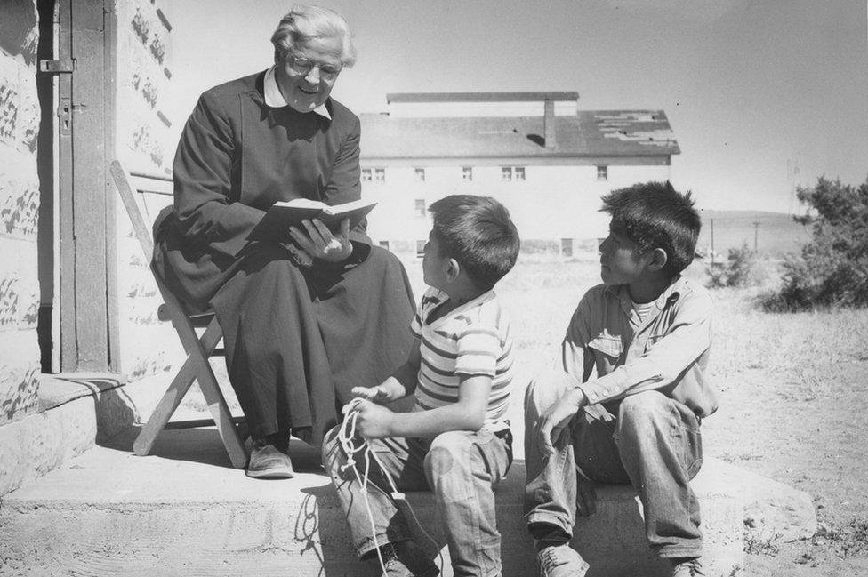 Gareth Hughes reads to children outside St Mary's