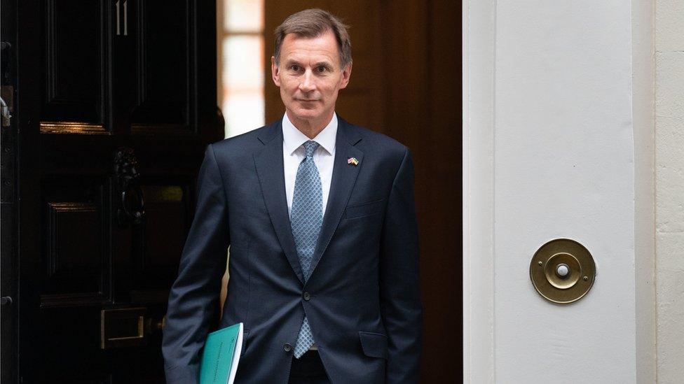 Chancellor Jeremy Hunt is pictured stepping out of 11 Downing Street