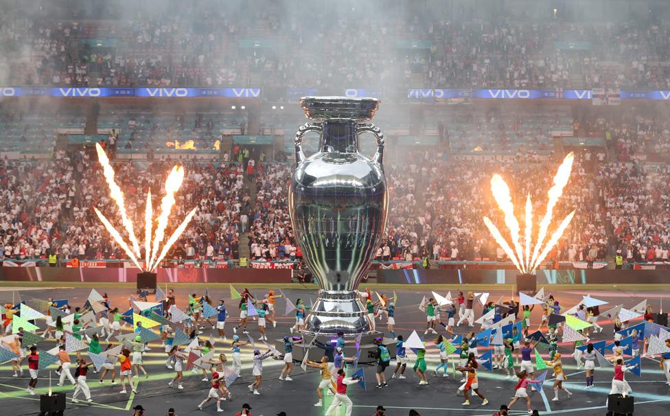 A large replica of The Henri Delaunay Trophy is seen whilst performers dance inside the stadium prior to the UEFA Euro 2020 Championship Final between Italy and England at Wembley Stadium on July 11, 2021 in London, England.