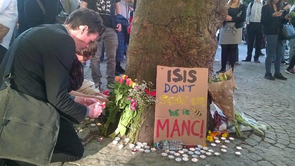 People light candles in Albert Square