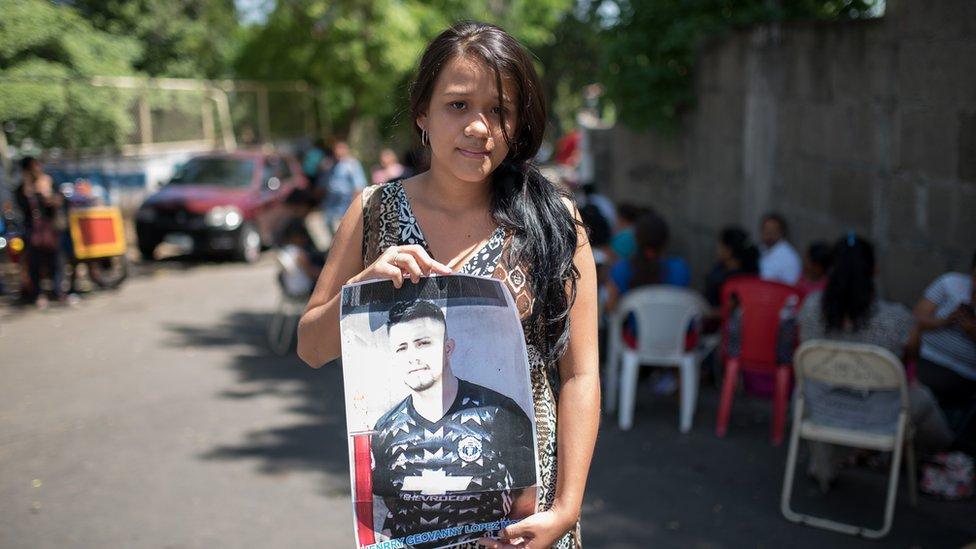 Elizabeth del Rosario Cano Molina holds a picture of her husband