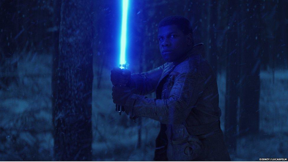 Finn, played by John Boyega wields a lightsaber