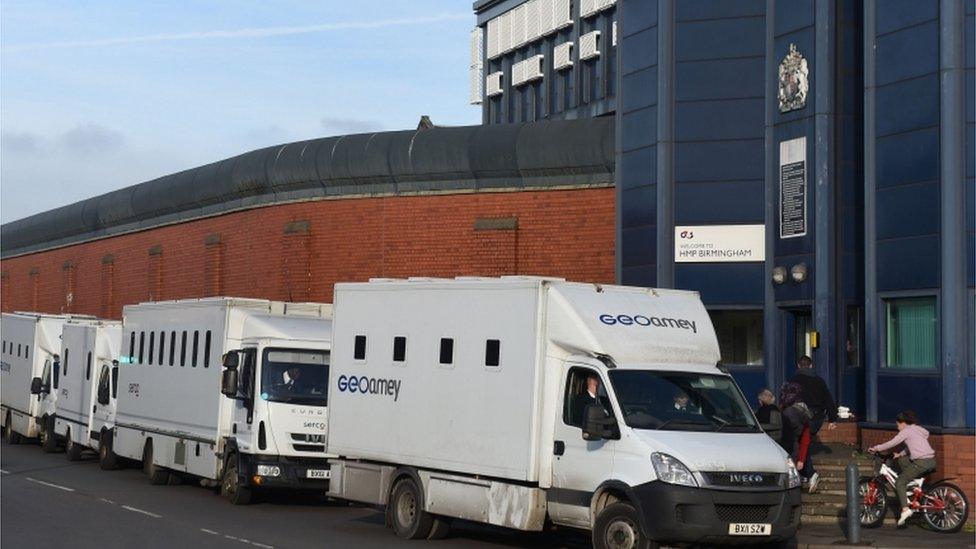 Custody vans wait to take prisoner away