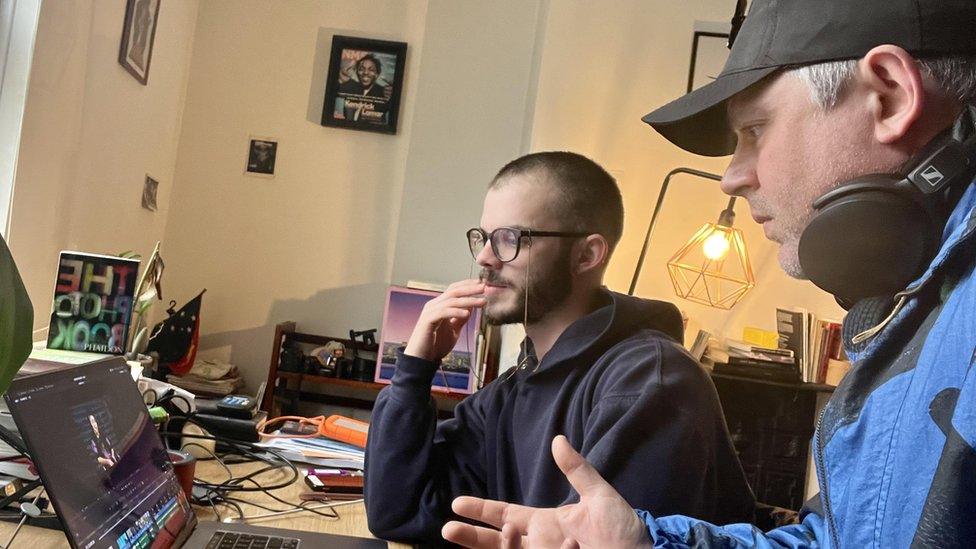 Tom Whitson and Colin Moody sitting at a computer working on the edit of the film