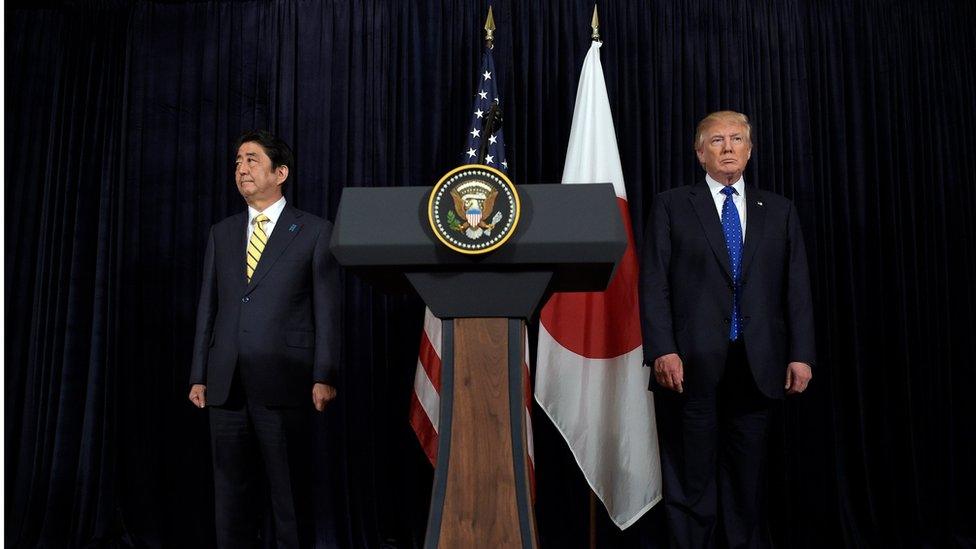 President Donald Trump, right, and Japanese Prime Minister Shinzo Abe, left, listen to the translator after they both made statements about North Korea at Mar-a-Lago in Palm Beach, USA, Saturday, Feb. 11, 2017.