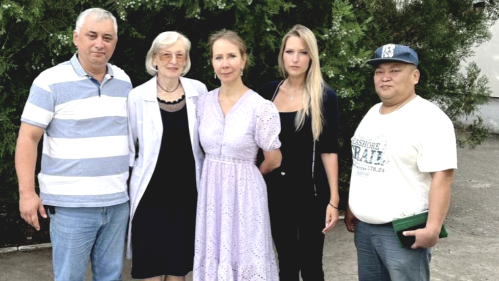 The "woman in lilac" later identified as Inna Varlamova standing at the centre of a line up of five people