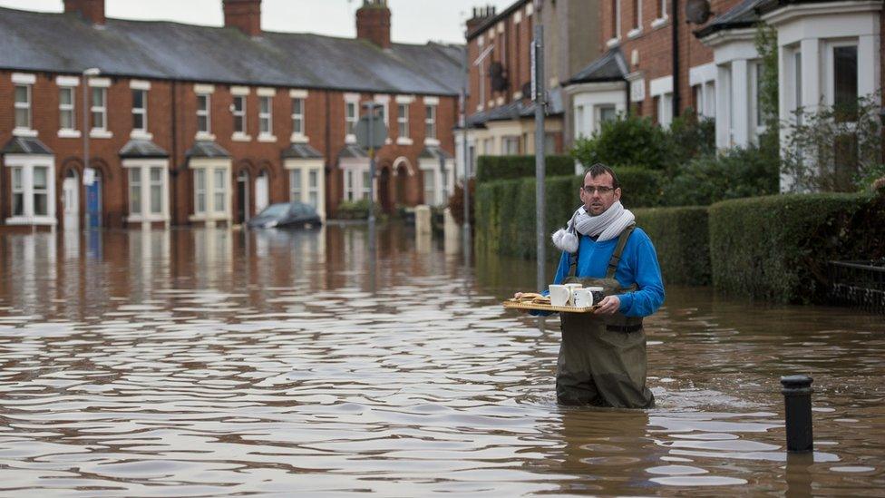 Man with drinks in flood water