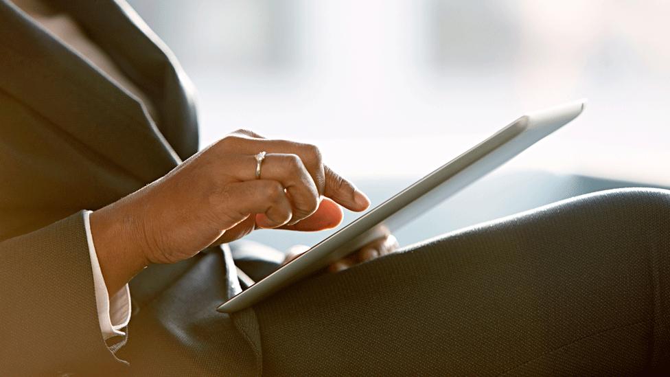 A woman using a touch-screen tablet computer