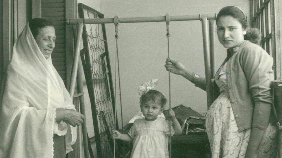 Iman Kishawi (center) sits on swing in Gaza in 1959 between her mother (right) and her grandmother (left)