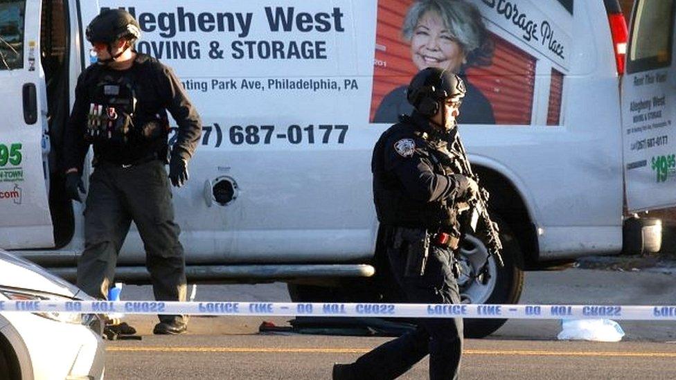 Law enforcement officers conduct an investigation of a van that police say is connected with the shooting at a subway station in the Brooklyn borough of New York City