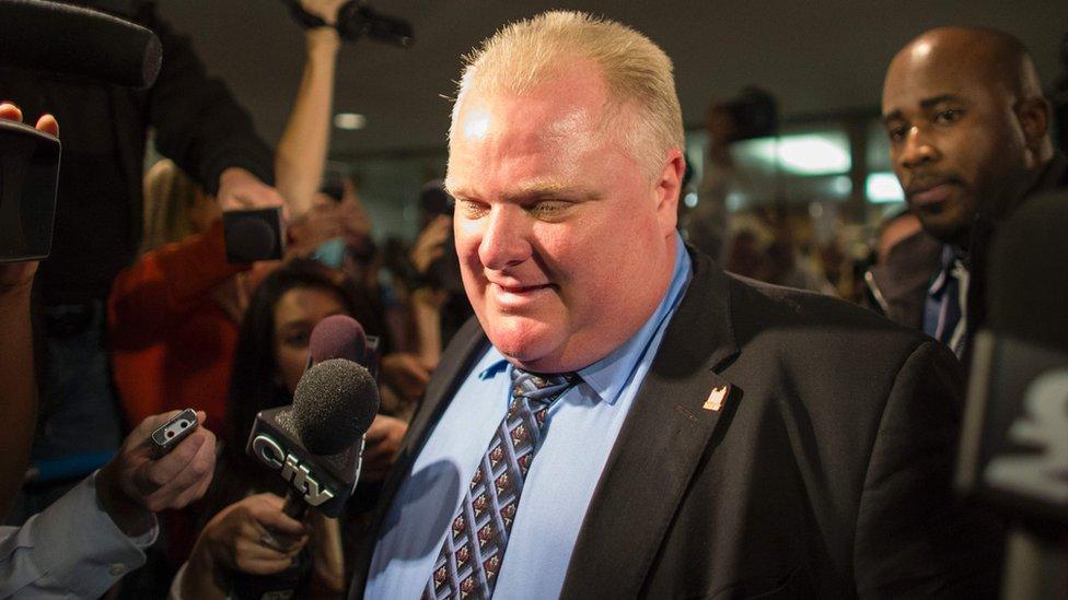 This file photo taken on 15 November 2013 shows former Toronto Mayor Rob Ford surrounded by the media as he leaves his office at Toronto City Hall.