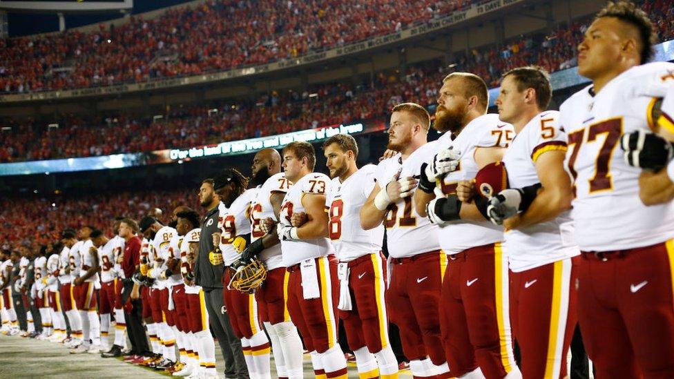 The Redskins team all stood for the national anthem in Kansas City