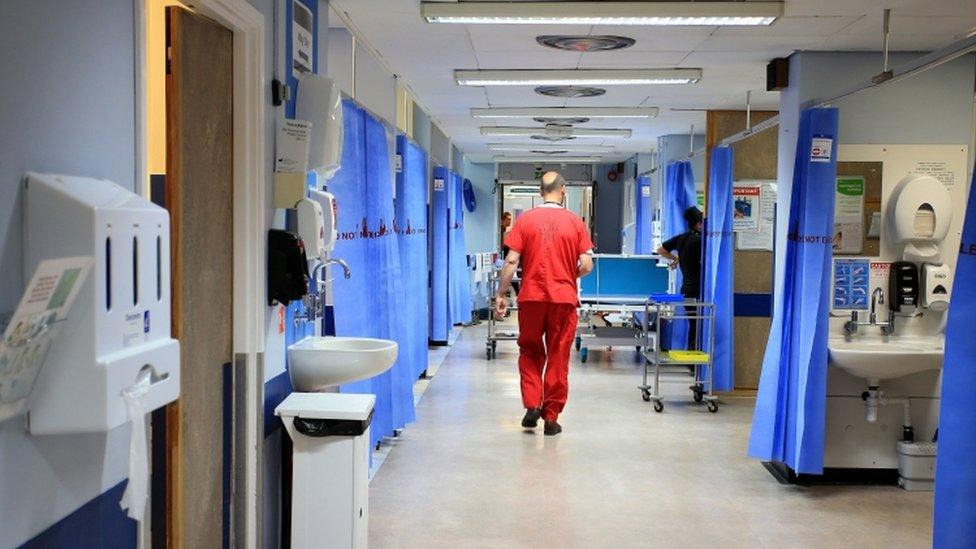 Nurse walks through an NHS hospital