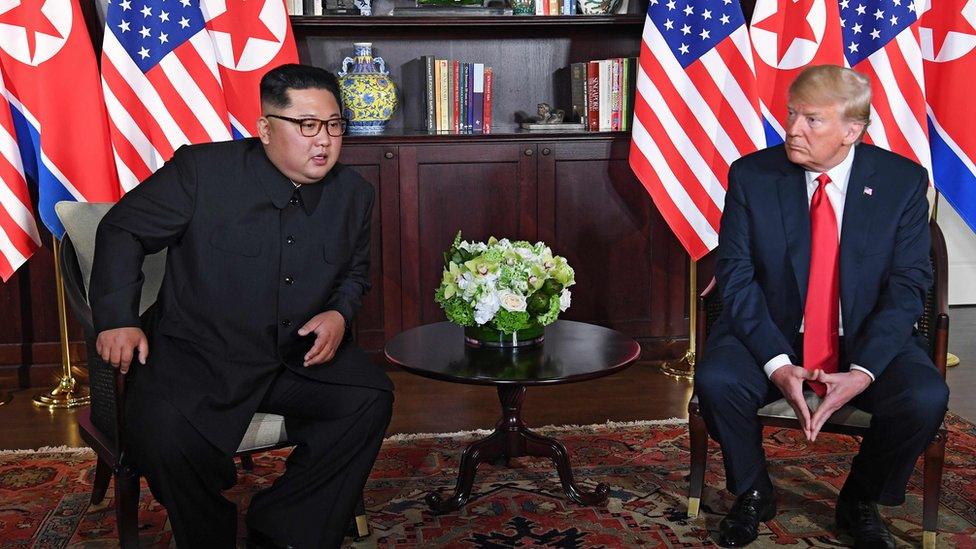 US President Donald Trump (R) and North Korea"s leader Kim Jong Un (L) sit down for their historic US-North Korea summit,