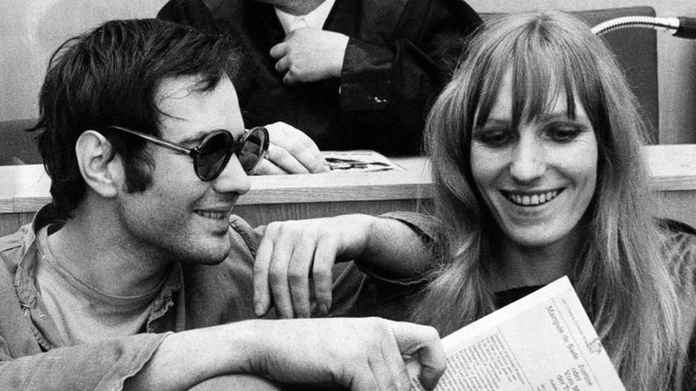 Andreas Baader (left) and Gudrun Ensslin joke during their trial in Frankfurt in October 1968