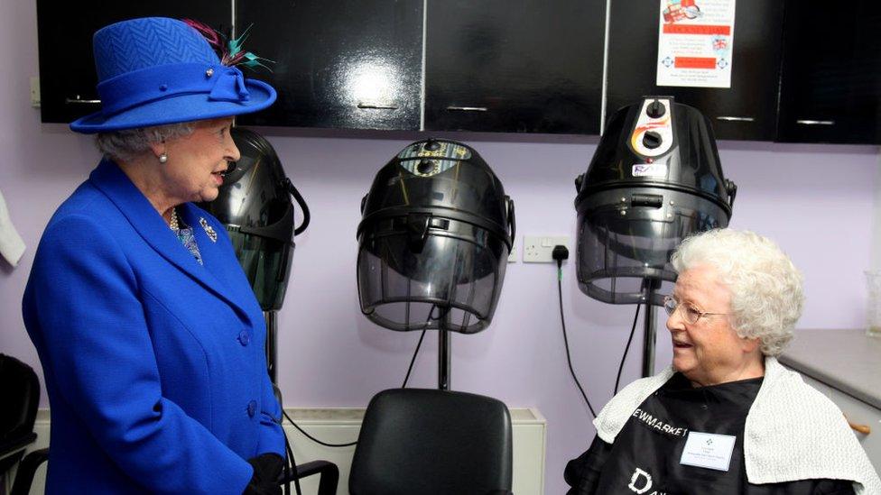 Queen Elizabeth II chats to Vera Smith, from Stetchworth, Suffolk, during a visit to the hair dressers of the Newmarket Day Centre on May 3, 2011.