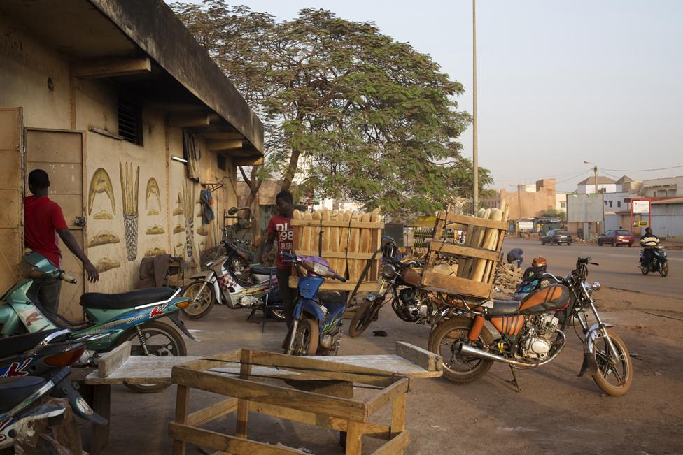 Men prepare motorbikes to be sent out to make deliveries at Buru Niouman Bakery in Bamako, Mali on 5 February 2019.