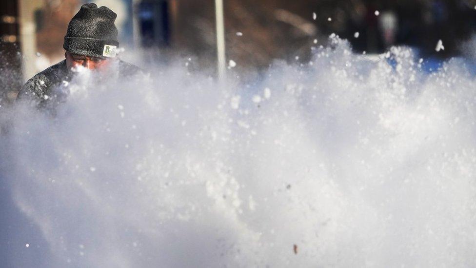 A man shovels snow to clear passage in Minneapolis, Minnesota state. Photo: 22 December 2022