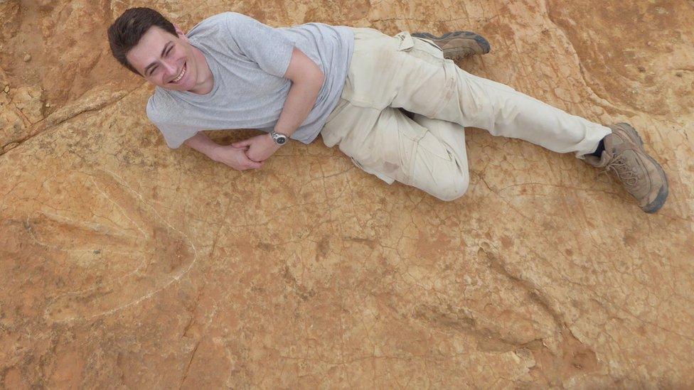 Dr Fabien Knoll lies next to the massive footprints