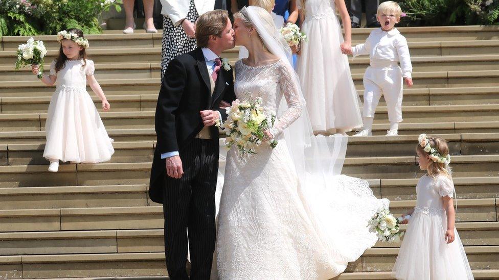 Newlyweds Thomas Kingston (L) and Lady Gabriella Windsor share a kiss on the steps of St George"s Chapel in Windsor Castle