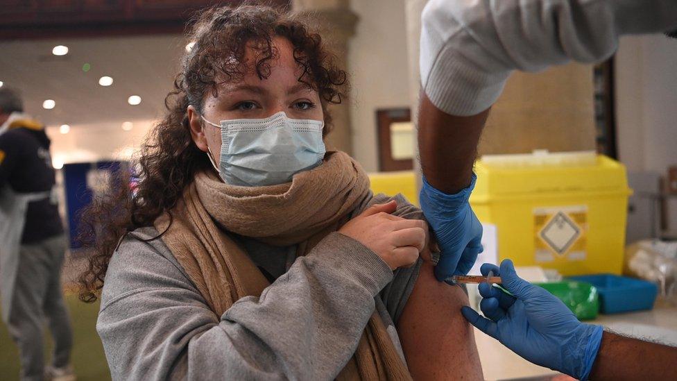 A woman receives the AstraZeneca Covid19 vaccine at an NHS vaccination centre in Ealing, west London, Britain 12 February, 2021. UK is close to completing first step of the vaccination programme, with 13.5m people having had a first jab according to NHS England.