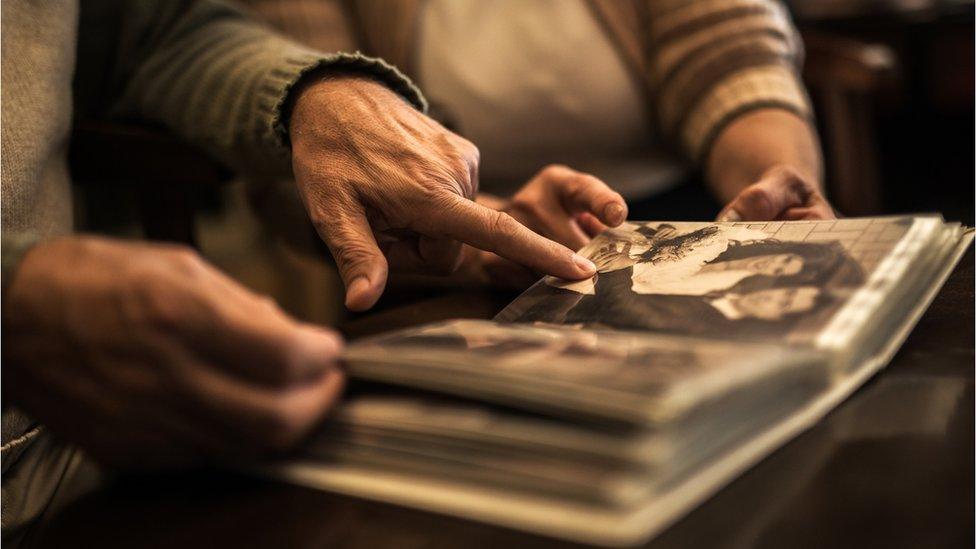 Old people looking at photo album