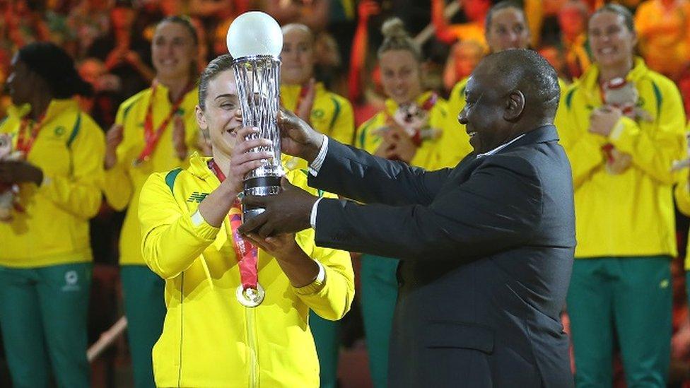 Australia captain Liz Watson receives the World Cup Trophy from South African President Cyril Ramaphosa during the Netball World Cup