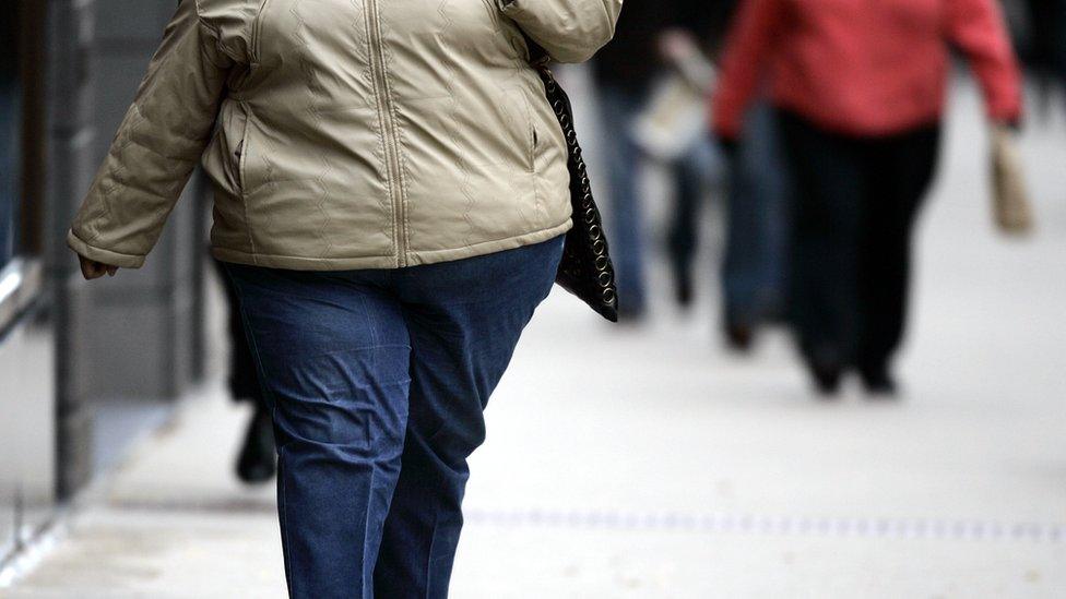 An obese woman walking on a street (file photo)