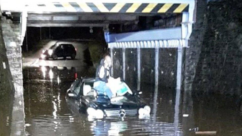 A man stranded on the roof of his car after getting stuck in flood water in Swansea