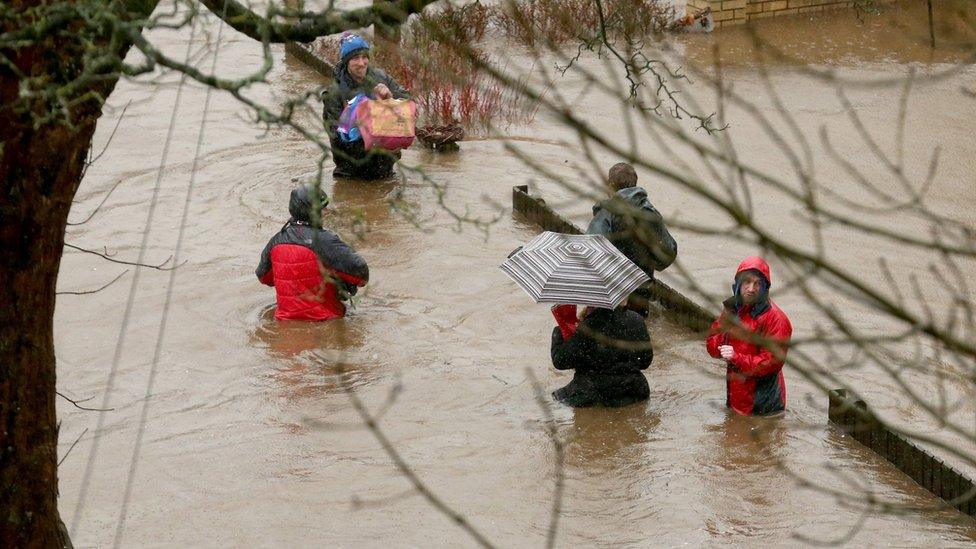 People in flooded street in Mytholmroyd, West Yorkshire