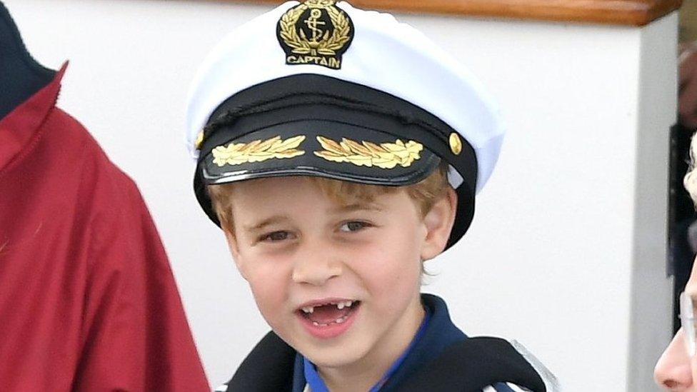 Prince George shows a toothy grin as he cheers on his parents, the Duke and Duchess of Cambridge, during the charity sailing regatta