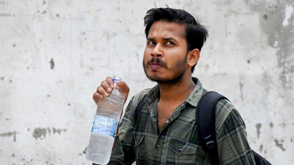 man-holding-water-bottle