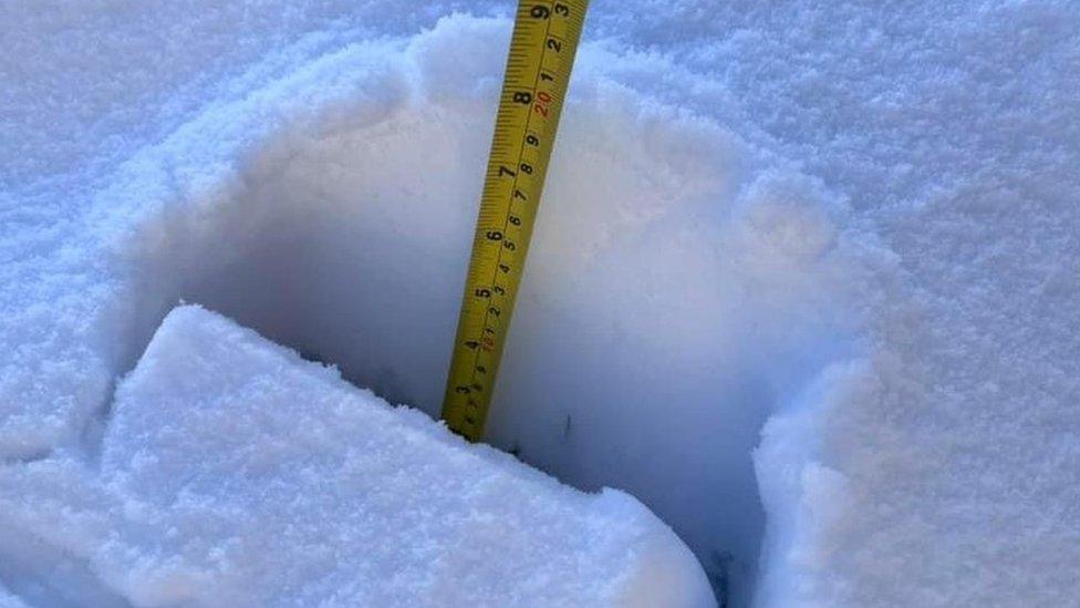 Tape measure showing depth of snow