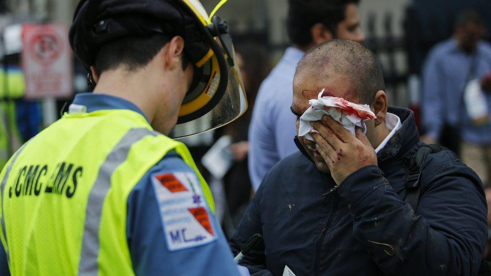 Emergency workers treat wounded people after the crash