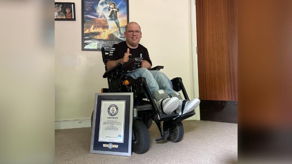 Adam Stanton-Wharmby with his framed world record