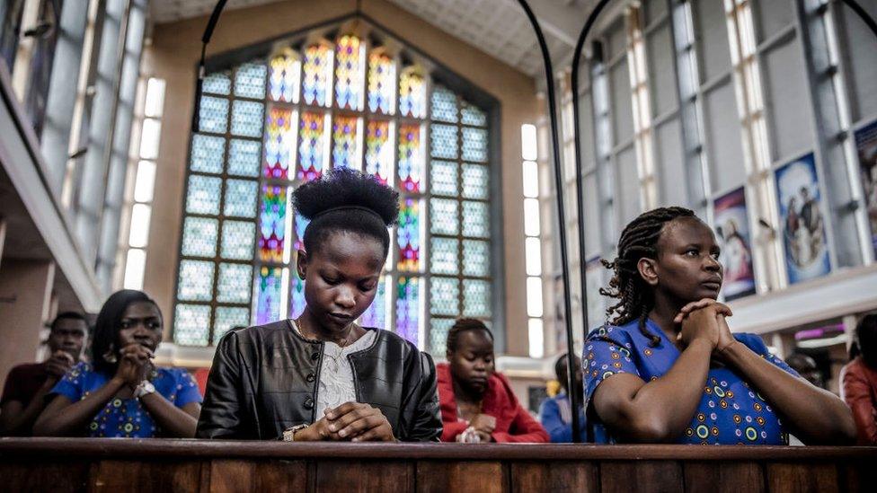 Catholics pray during a sermon talking about the COVID-19 coronavirus during a Sunday Mass at Holy Family Minor Basilica in Nairobi, Kenya on March 22, 2020