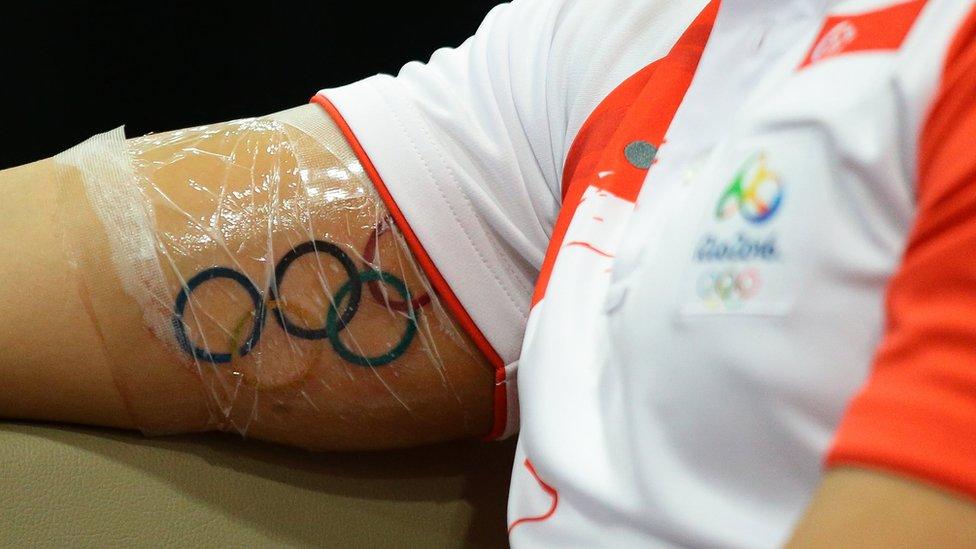 The Olympic Rings tattoo is seen on Singaporean Swimmer Joseph Schooling arm as he speaks to the media during a press conference at the OCBC Aquatic Centre on August 16, 2016 in Singapore