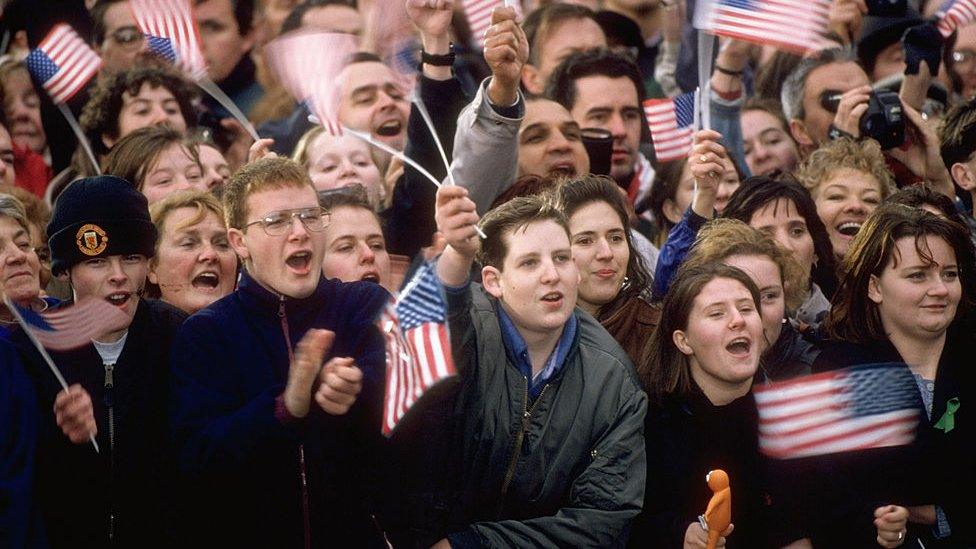 Youths standing out amid US flag-waving crowd out to greet visiting US Pres. Bill Clinton; Londonderry.