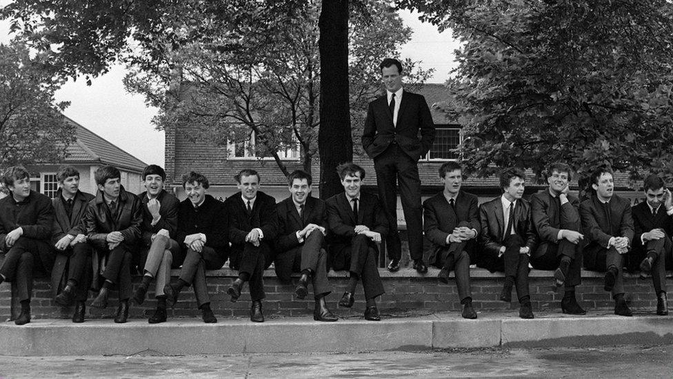 Brian Epstein standing with The Beatles, Gerry and the Pacemakers, and Billy J Kramer and The Dakotas sitting down