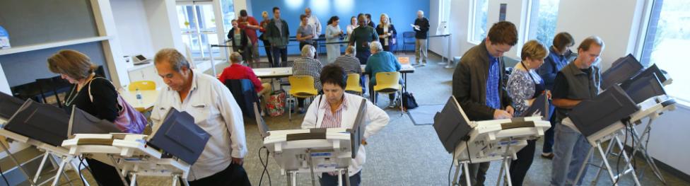 People cast their ballots on electronic voting machines on the first day of early voting in Provo, Utah - 25 October 2016