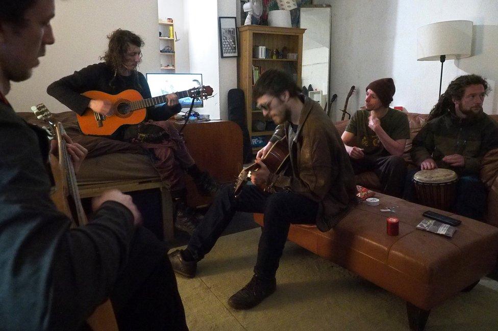 A group of people playing guitars