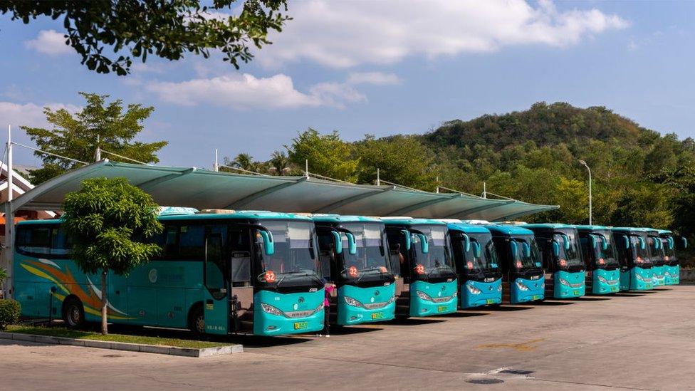 Electric buses at a charging station in Sanya, on Hainan Island, in the People's Republic of China