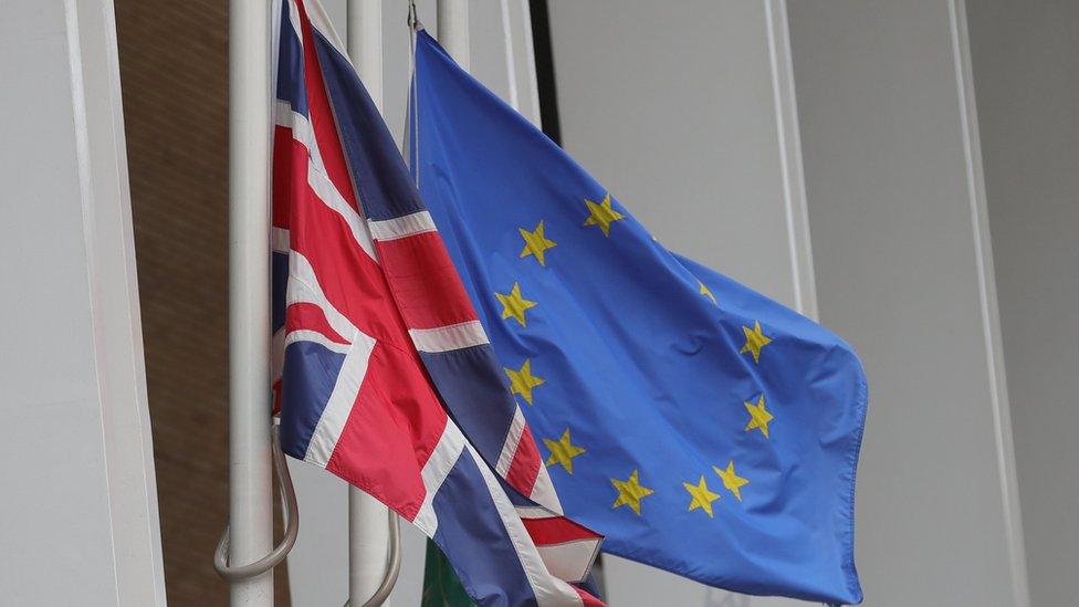 UK and EU flags fly at half mast outside the Shangri-La Hotel at The Shard in London